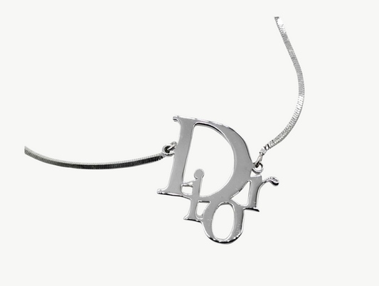 A silver-tone Dior logo pendant necklace on a delicate chain, shown against a plain white background.